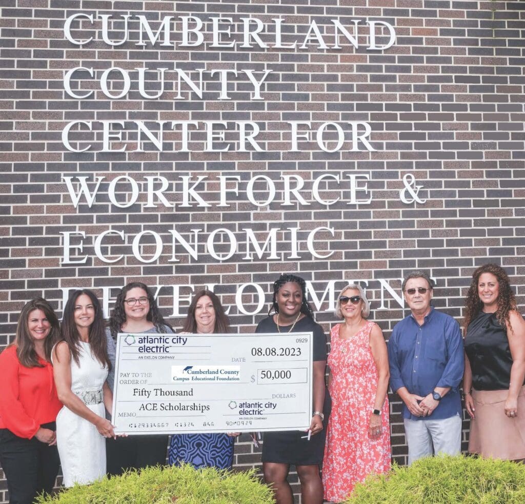 A group of people standing in front of the cumberland county center for workforce and economic development.