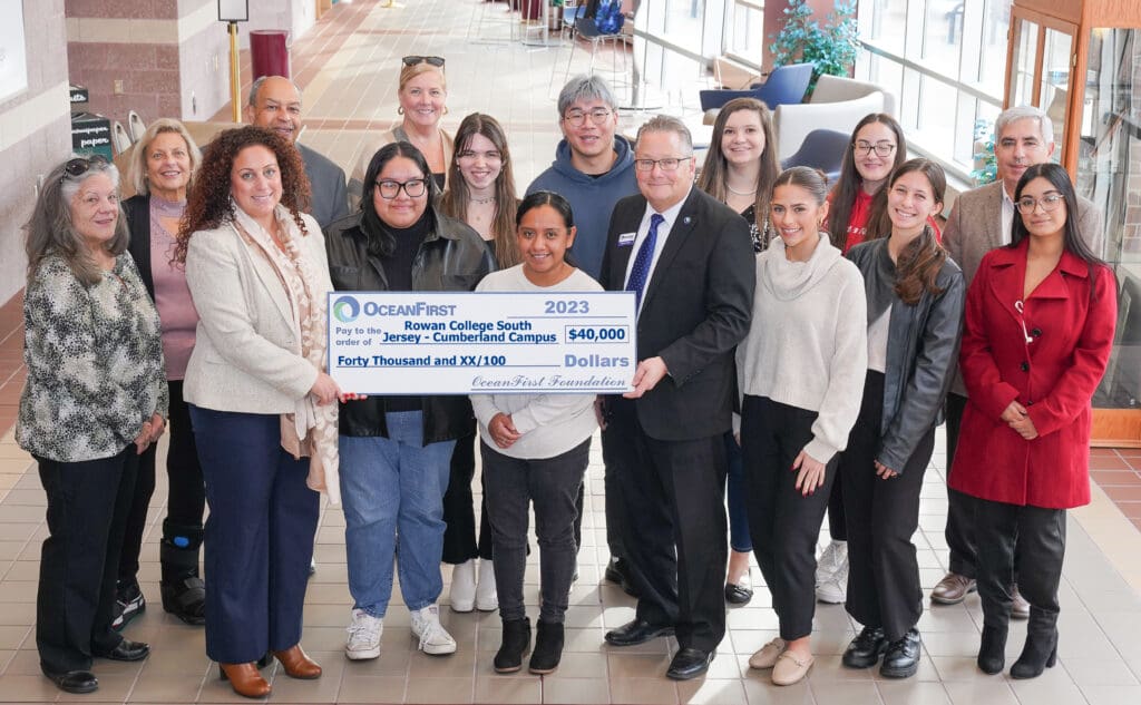 A group of people posing for a picture with a check.