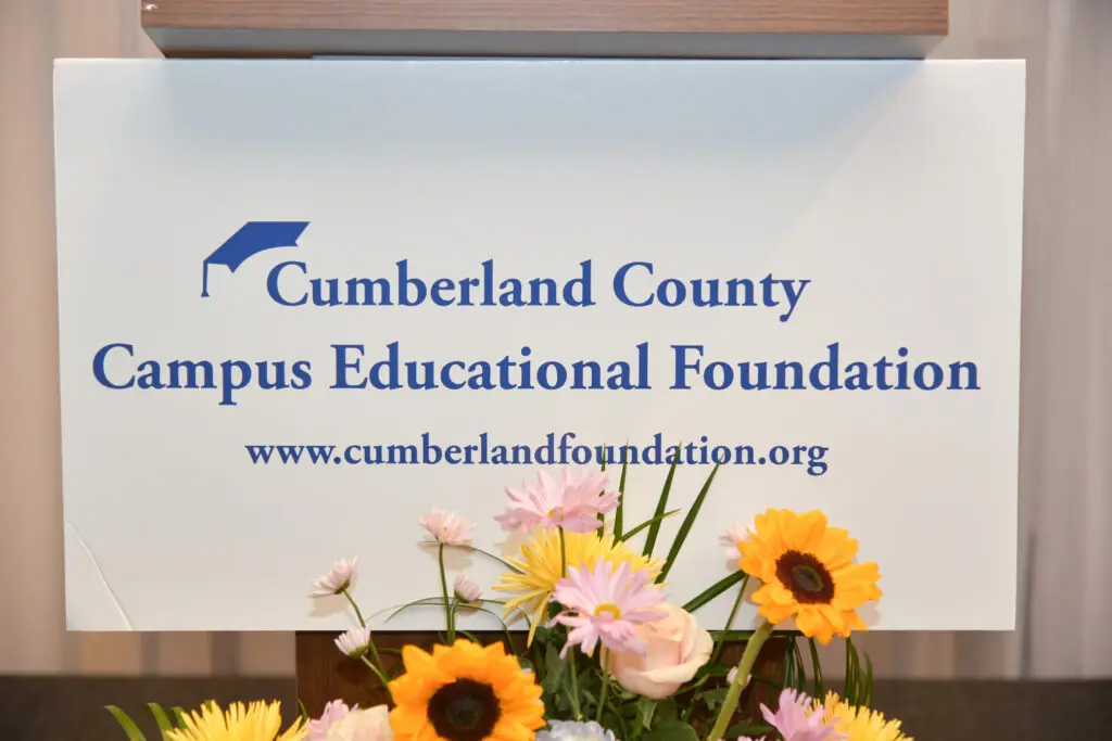 Welcome sign for Cumberland County Campus Educational Foundation with flowers.