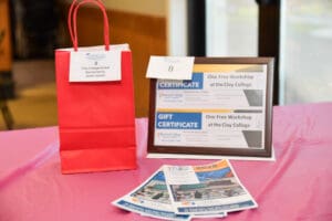 Red gift bag and certificates on table.