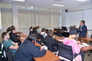 Classroom lecture with attentive students and instructor.