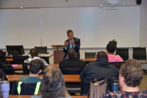 Man speaking to a classroom audience.