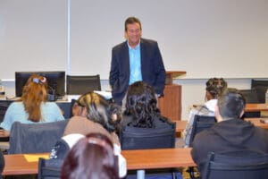 Man speaking to a classroom of students.