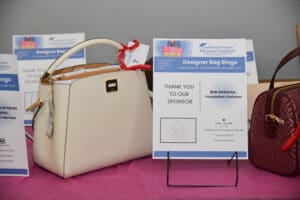Designer handbags displayed on a table.