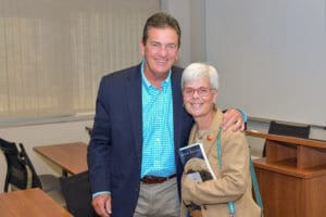 Smiling man and woman in a classroom.