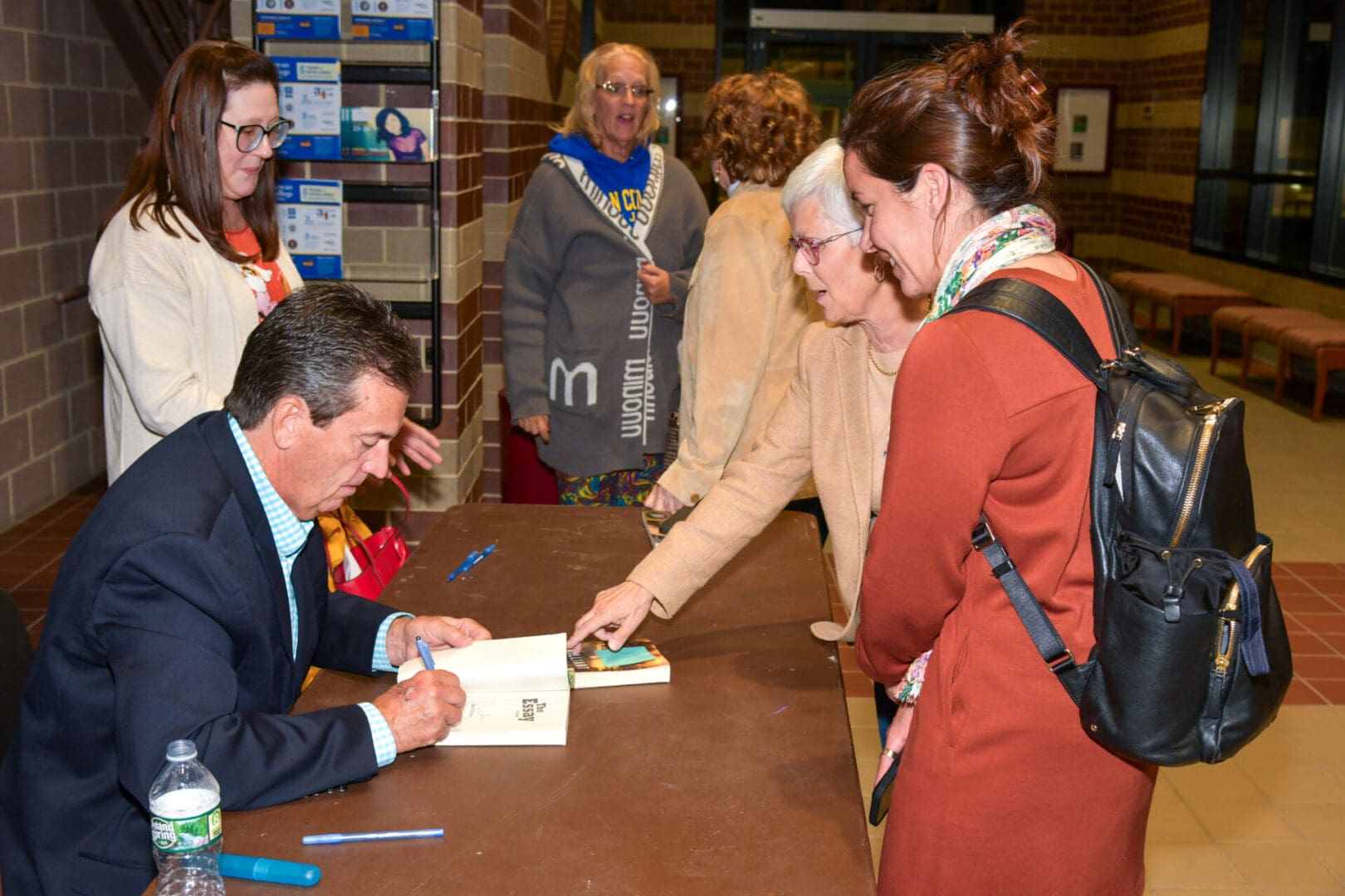 Author signing books for attendees.