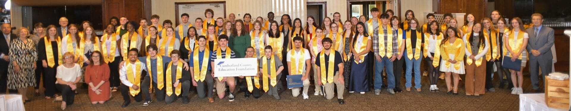 Students wearing gold stoles at awards ceremony